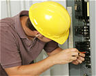 Qualified Electrician Inspecting Electrical Panel